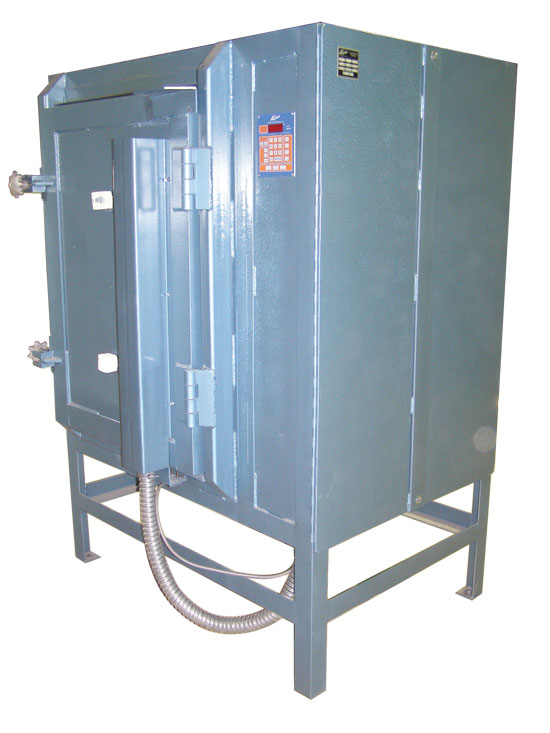 An electric kiln, approximately 5 feet tall, with the door closed